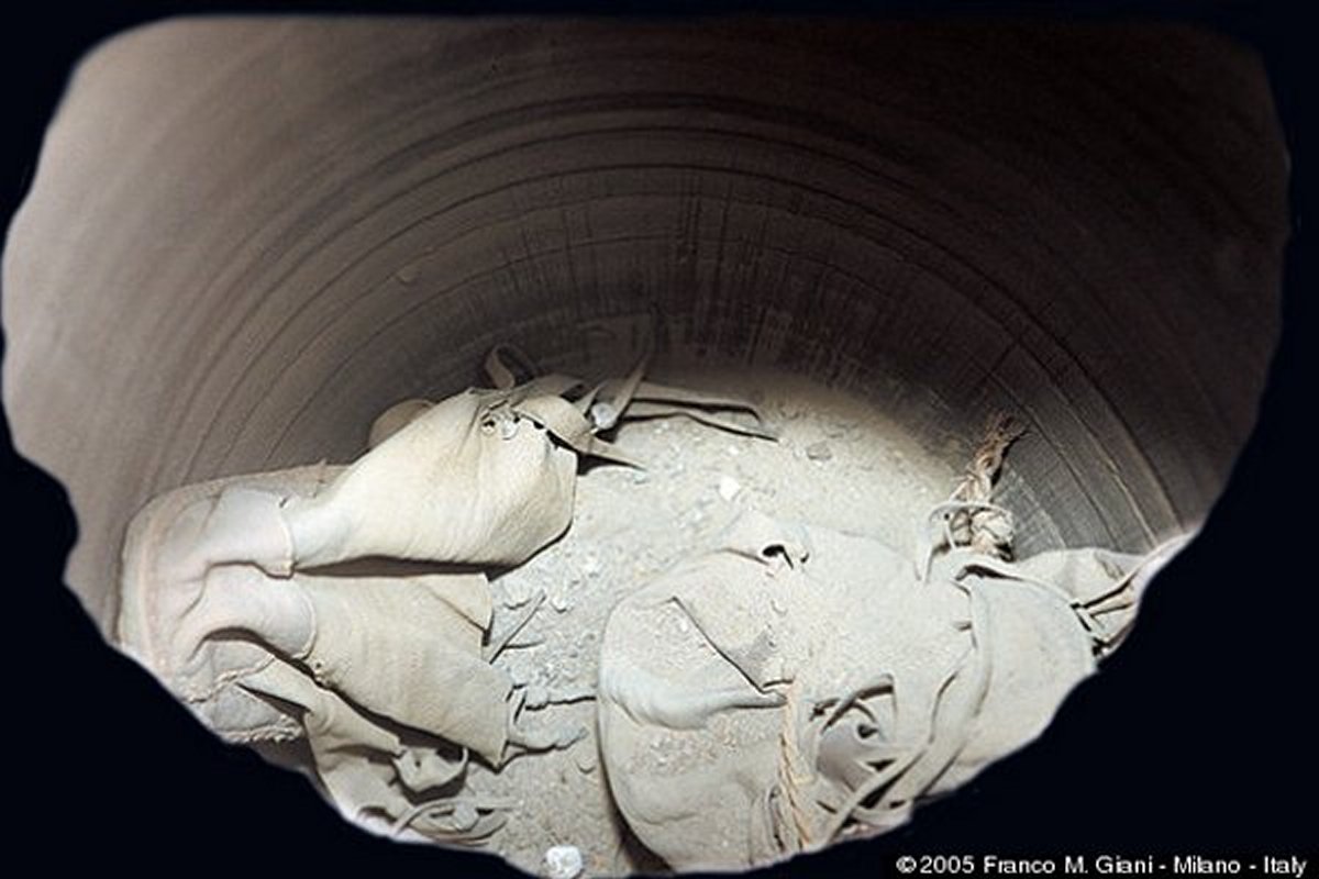 The shoes date back more than 2,000 years and this picture shows the inside of the jar before the shoes were removed.