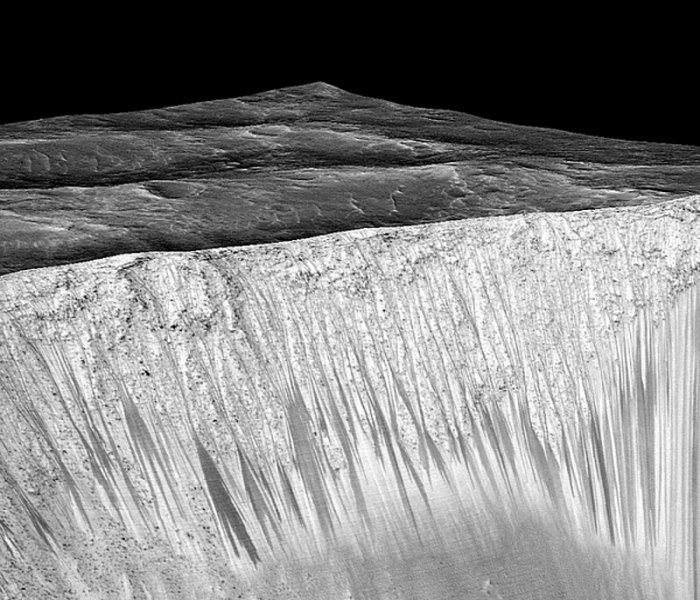 Dark narrow streaks called recurring slope lineae emanate out of the walls of Garni crater on Mars. Photograph: Nasa/AFP/Getty Images