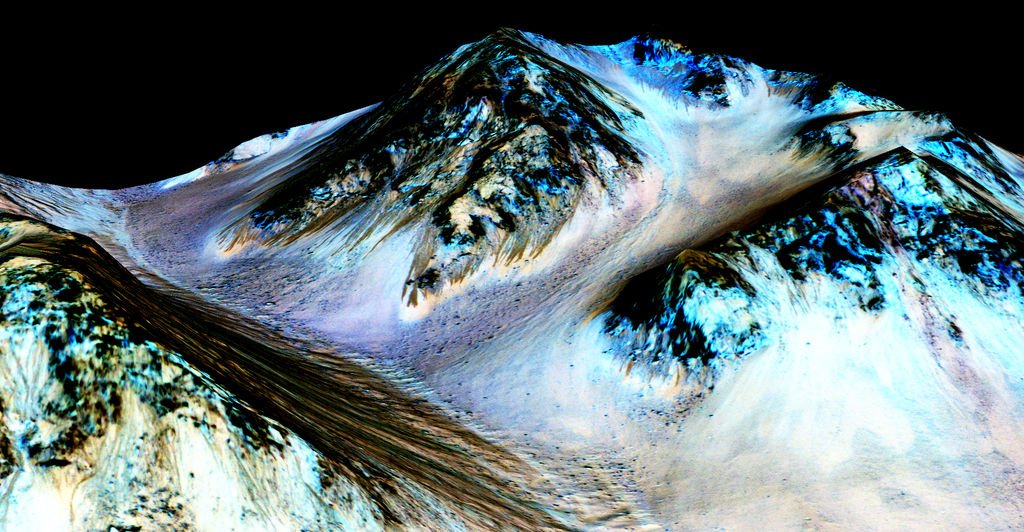 Dark, narrow streaks on Martian slopes such as these at Hale Crater are inferred to be formed by seasonal flow of water on contemporary Mars. The streaks are roughly the length of a football field. Credit: NASA/JPL-Caltech/Univ. of Arizona