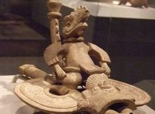 Ancient reptilian riding a vehicle