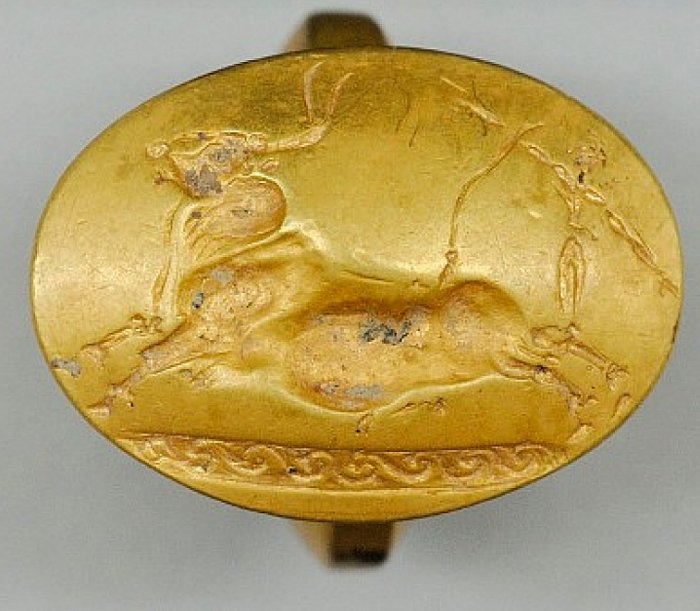 This gold ring with a Cretan bull-jumping scene was one of four solid-gold rings found in the tomb. This number is more than found with any other single burial elsewhere in Greece.