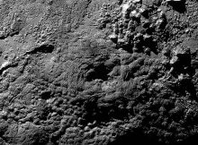 A possible ice volcano on Pluto (visible at center) is seen in this NASA image, captured by the New Horizons spacecraft, released on Nov. 9, 2015. The feature, called Wright Mons, is a strange feature 100 miles wide and 13,000 feet high with a summit depression at its center. New Horizons scientists suspect Wright Mons and another mountain may be signs of cryovolcanic eruptions on Pluto. Credit: NASA/Johns Hopkins University Applied Physics Laboratory/Southwest Research Institute
