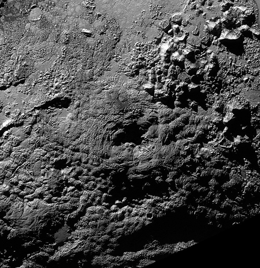 A possible ice volcano on Pluto (visible at center) is seen in this NASA image, captured by the New Horizons spacecraft, released on Nov. 9, 2015. The feature, called Wright Mons, is a strange feature 100 miles wide and 13,000 feet high with a summit depression at its center. New Horizons scientists suspect Wright Mons and another mountain may be signs of cryovolcanic eruptions on Pluto. Credit: NASA/Johns Hopkins University Applied Physics Laboratory/Southwest Research Institute