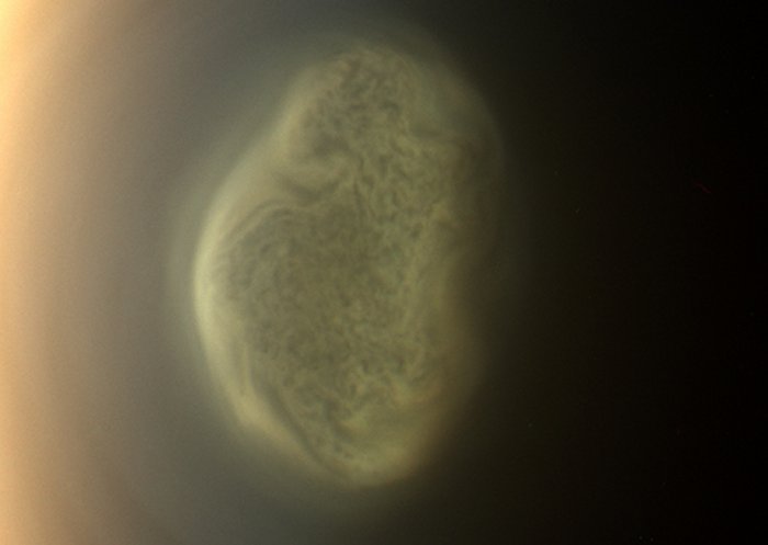 This 2012 close-up offers an early snapshot of the changes taking place at Titan’s south pole. Cassini’s camera spotted this impressive cloud hovering at an altitude of about 186 miles (300 kilometers). Cassini’s thermal infrared instrument has now detected a massive ice cloud below it. Credits: NASA/JPL-Caltech/Space Science Institute