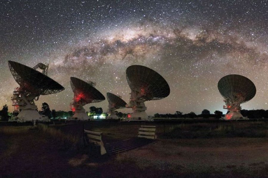 CSIRO's Compact Array in Australia is shown under the night lights of the Milky Way. Credit: Alex Cherney