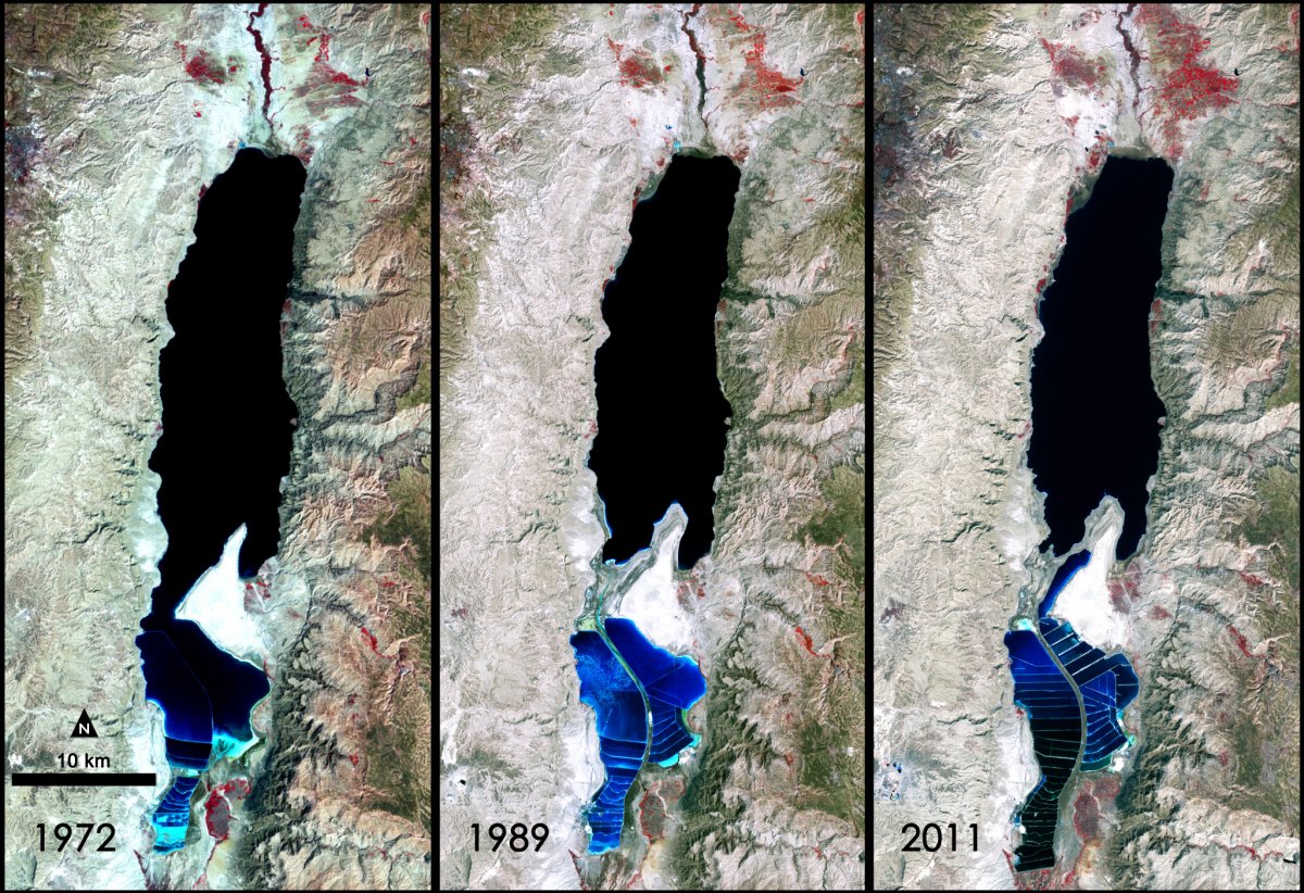 This false-color image was captured by the Landsat 1, 4 & 7 satellites. Visible is the Lisan Peninsula (bottom center) that forms a land bridge through the Dead Sea. Deep waters are dark blue, while pale blue shows salt ponds and shallow waters to the south. The pale pink and sand-colored regions are desert lands. Denser vegetation appears bright red. Credit: NASA/Landsat