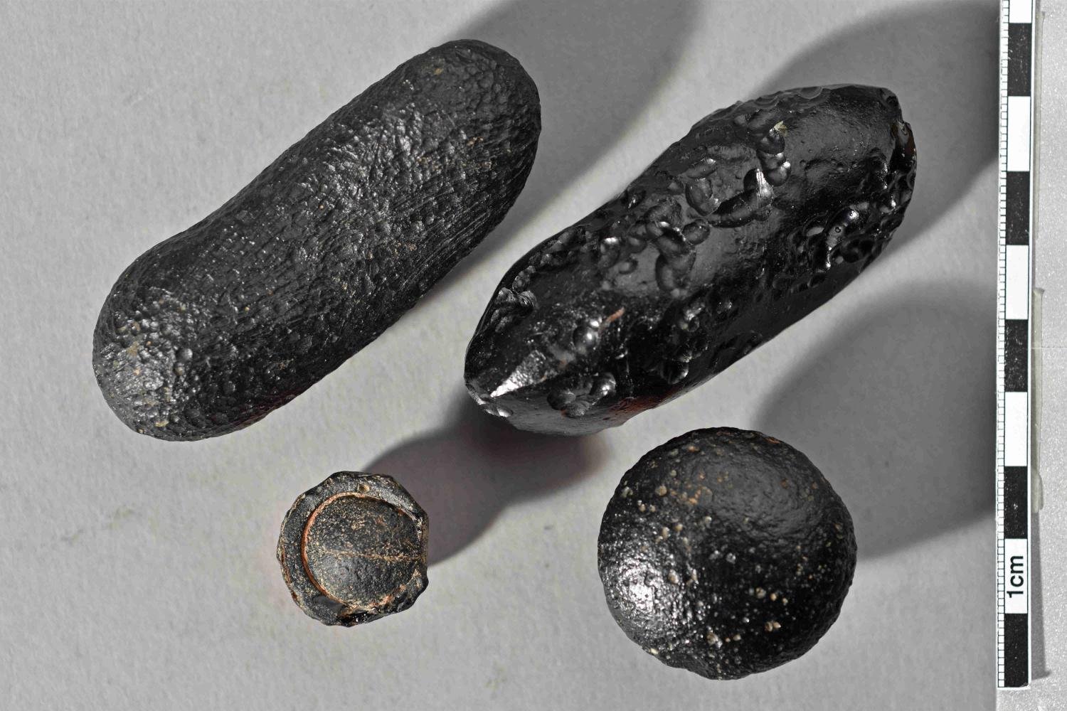 Tektite from Australia with flanged edge. The force of the impact blew the glass body thousands of kilometres and out of the earth's atmosphere. The bulging edge formed when the partially molten tektite re-entered the atmosphere.' Photo: Institut für Geowissenschaften, Universität Heidelberg