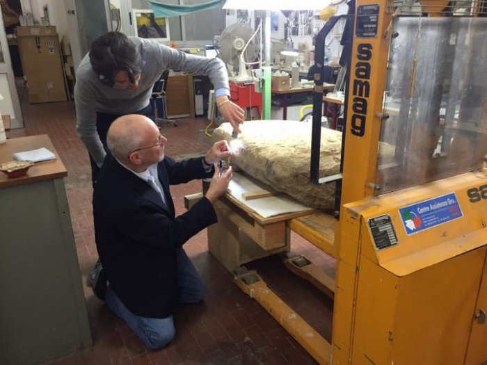 Scientists examine the Etruscan stele, weighing about 500 pounds and nearly four feet tall by more than two feet wide.