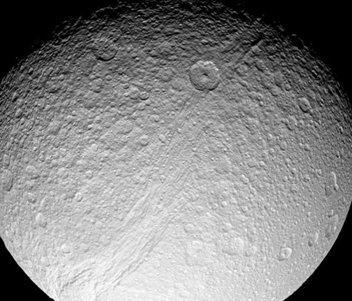 Saturn's moon Tethys, with its giant canyon Ithaca Chasma. We propose that Ithaca Chasma was opened by strong tidal forces millions of years ago when Tethys was in an orbital resonance with the neighboring moon Dione. credit:NASA