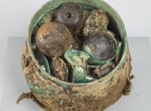 The cache of objects were, until recently, contained in a ‘Carolingian’ (West European) vessel, or pot, which was part of a wider hoard, amounting to around a hundred items, which includes a large number of silver ingots and armrings, a beautifully-preserved cross, and an ornate gold pin in the likeness of a bird. Credits: HIstoric Scotland