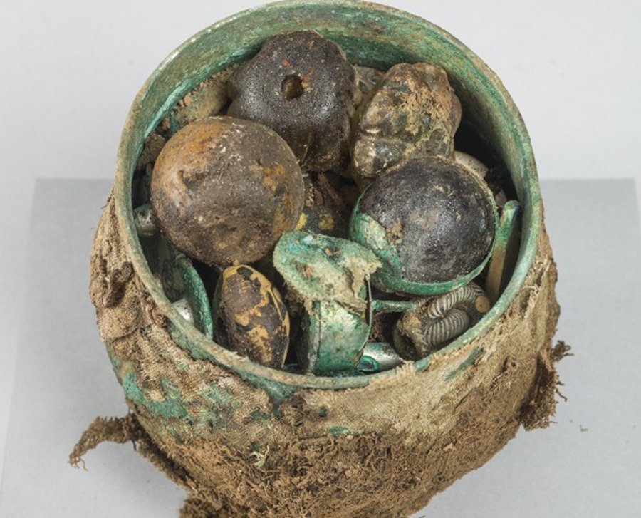 The cache of objects were, until recently, contained in a ‘Carolingian’ (West European) vessel, or pot, which was part of a wider hoard, amounting to around a hundred items, which includes a large number of silver ingots and armrings, a beautifully-preserved cross, and an ornate gold pin in the likeness of a bird. Credits: HIstoric Scotland