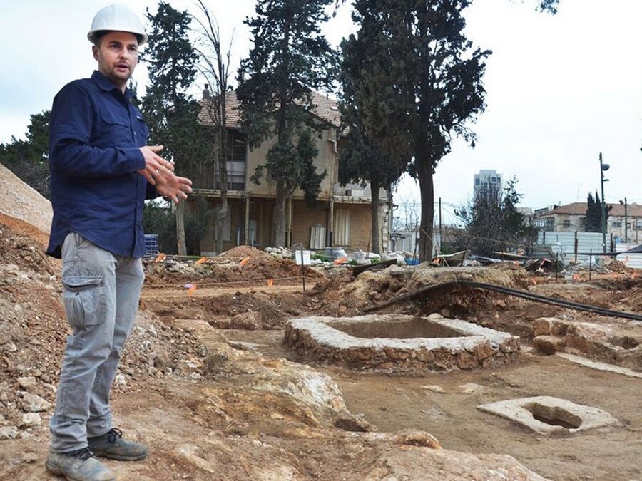 Alex Wiegmann, excavation director, views winepress uncovered in Schneller Compound Copyright: Courtesy Israel Antiquities Authority