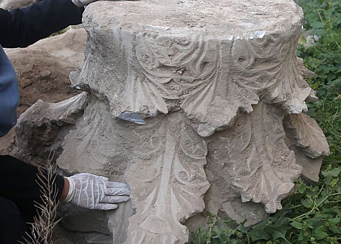 Palestinian archaeologist Hyam al-Betar looks at artifacts excavated during the construction of a commercial building in Gaza City, on April 4, 2016. AFP - Photo via Haaretz