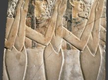 Ancient relief of clapping Egyptian women.