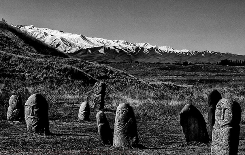 Balbals - near the Ala Tou Mountains. Stone statues made by Turkic people of Central Asia face east and guard grave sites.There faces have been worn by the harsh weather, 14 centuries worth of harsh weather, but their features and clothing are still discernible. The statues were about 3 feet tall but I read that another meter of stone anchors them in the sandy soil. 