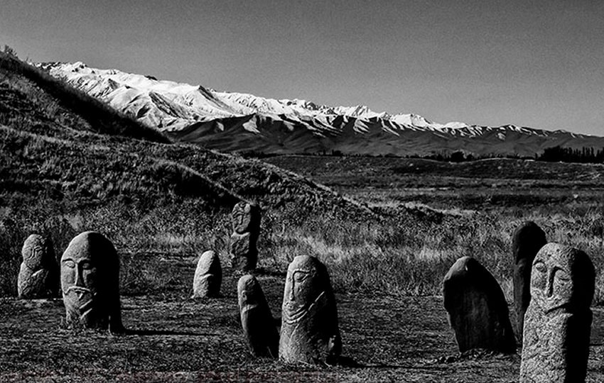 Balbals - near the Ala Tou Mountains. Stone statues made by Turkic people of Central Asia face east and guard grave sites.There faces have been worn by the harsh weather, 14 centuries worth of harsh weather, but their features and clothing are still discernible. The statues were about 3 feet tall but I read that another meter of stone anchors them in the sandy soil.
