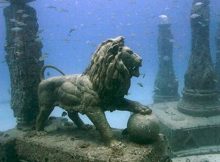 A lion statue standing underwater.