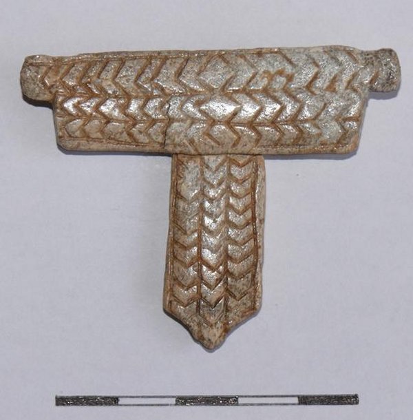 A T-shaped bone ornament discovered in the tomb, in Kowal neolithic site, Poland