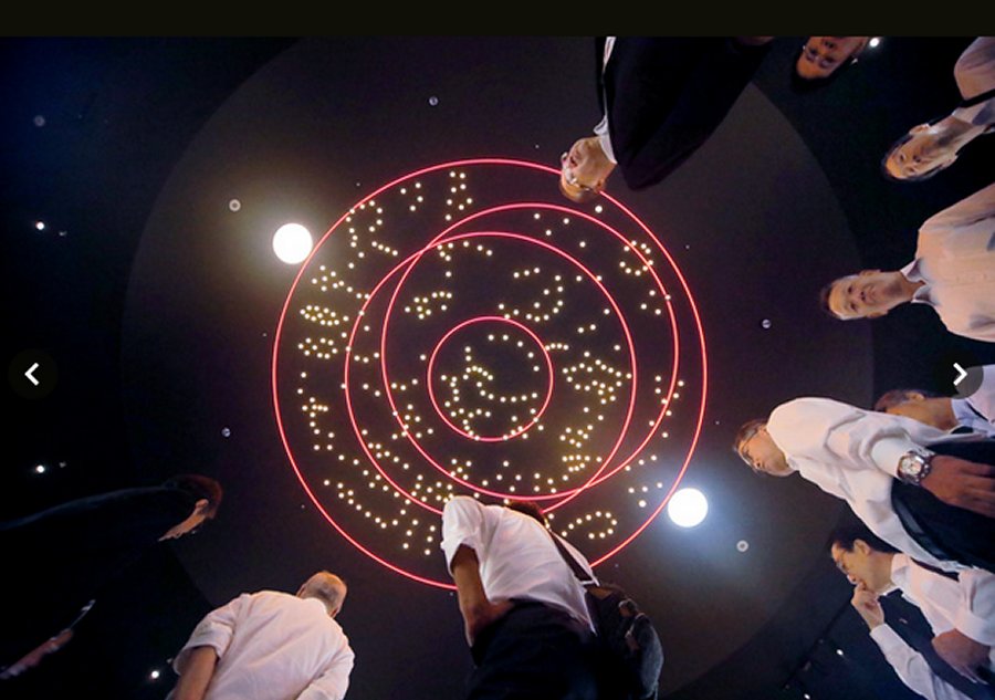 Visitors peer up at an image of the Kitora burial mound’s star chart projected onto the ceiling of the Kitora Tumulus Mural Experiential Museum “Shijin no Yakata” in Asuka, Nara Prefecture.(Asahi Shimbun file photo)