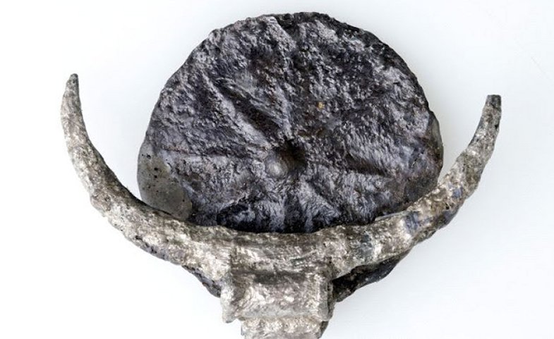 Silver pendant featuring a disc with a relief carving of an eight-pointed star, found in the biblical city of Gezer. Credit: Clara Amit, IAA