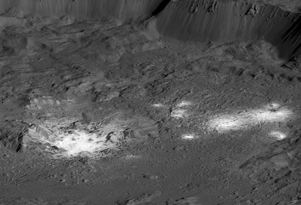 The bright areas of Occator Crater -- Cerealia Facula in the center and Vinalia Faculae to the side -- are examples of bright material found on crater floors on Ceres. This is a simulated perspective view. Credit: NASA/JPL-Caltech/UCLA/MPS/DLR/IDA/PSI