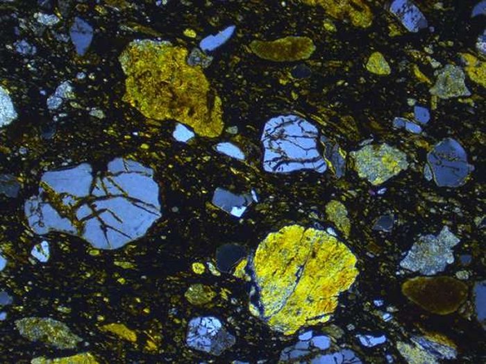 Thin section view of meteoritic ejecta deposit site 1. Note fractured quartz and pervasive fabric. Field of view 4 mm XPolars. Credit: Simon Drake.
