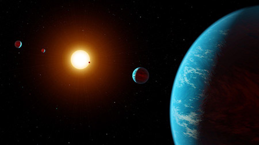 Artist’s visualization of the K2-138 system, the first multi-planet system discovered by citizen scientists. The central star is slightly smaller and cooler than our sun. The five known planets are all between the size of Earth and Neptune; planet b may potentially be rocky, but planets c, d, e, and f likely contain large amounts of ice and gas. All five planets have orbital periods shorter than 13 days and are all incredibly hot, ranging from 800 to 1800 degrees Fahrenheit. Credit: NASA/JPL-Caltech/R. Hurt (IPAC)