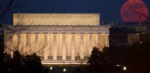 The full moon is seen as it rises near the Lincoln Memorial, Saturday, March 19, 2011, in Washington