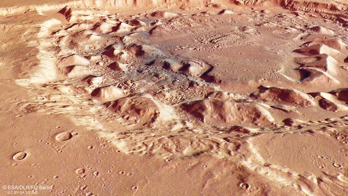 An oblique perspective view of Ismenia Patera, a crater located in the Arabia Terra region of Mars’ surface. It was taken on 1 January 2018 by the stereo channels of the High Resolution Stereo Camera on ESA’s Mars Express, and highlights the uneven terrain around and within the crater and the flow-marked deposits on the crater floor.Image credit: ESA/DLR/FU Berlin