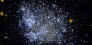 The dwarf irregular galaxy IC1613. Astronomers wondering whether primordial black holes might compose the dark matter in the universe suggest that the shapes of faint dwarf galaxies with dark matter halos might reveal the answer. NASA/JPL-Caltech/SSC