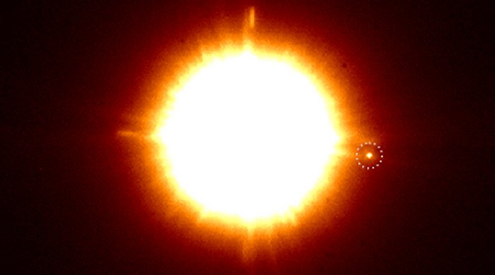 An infrared image of the binary CS Cha with the newly discovered companion in the dotted circle. Credit: C. Ginski & SPHERE