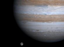 The solar system's largest moon, Ganymede, is captured here alongside the planet Jupiter in a color picture taken by NASA's Cassini spacecraft on Dec. 3, 2000. CREDIT NASA/JPL/University of Arizona