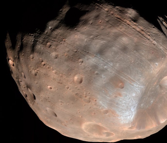 Groovy Phobos Much of Phobos' surface is covered with strange linear grooves. New research bolsters that idea the boulders blasted free from Stickney crater (the large depression on the right) carved those iconic grooves. NASA/JPL-Caltech/University of Arizona