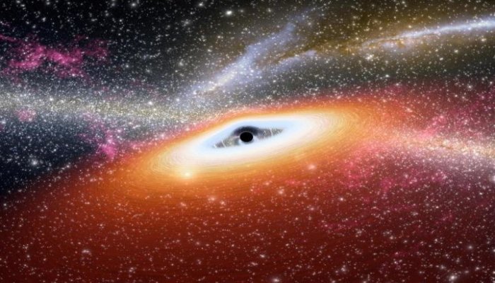 This is an artistic impression of a gas disk feeding a massive black hole while emitting radiation. Credit: NASA