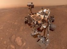 In a selfie taken in mid-January 2019, Mars rover Curiosity prepares to enter a new, clay-mineral-rich unit on its traverse up Mount Sharp in Gale Crater. Mission scientists are anxious to see what a new gravity-measuring technique will reveal about the mountain and Gale Crater's history. Credit: NASA/JPL-Caltech/MSSS