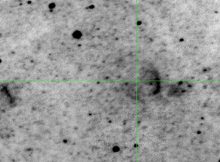 Crosshairs indicate the location of the nova studied. Remnant can be seen as a partial arc to the right of the nova.