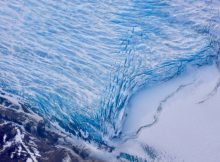 Cracks in the front of a glacier as it reaches the ocean. Credits: NASA/Adam Klein