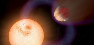 This illustration shows a hot Jupiter orbiting so close to a red dwarf star that the magnetic fields of both interact, triggering activity on the star. Astrophysicists have for the first time used observations of such activity to calculate field strengths in four hot Jupiter star-and-planet systems. Image credit: NASA, ESA and A. Schaller (for STScI)