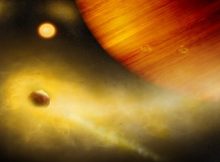 Artist's composition of a volcanic exo-Io undergoing extreme mass loss. The hidden exomoon is enshrouded in an irradiated gas cloud shining in bright orange-yellow, as would be seen with a sodium filter. Patches of sodium clouds are seen to trail the lunar orbit, possibly driven by the gas giant's magnetosphere. Credit: University of Bern, Illustration: Thibaut Roger