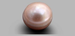 The 8,000-year-old pearl, which was discovered in 2017, is less than a third of a centimeter in diameter and in photos, appears to be pale pink in color.