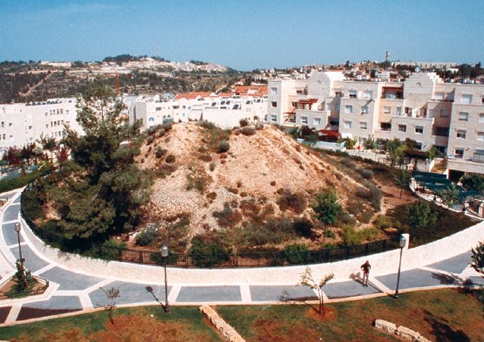 Nestled today within modern neighborhoods in western Jerusalem, the mound above and 19 others were once west of the city’s populated areas. The mounds, called tumuli, were clearly manmade but their purpose has eluded excavators for over a century. Credit: Garo Nalbandian