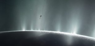 This artist's impression depicts NASA's Cassini spacecraft flying through a plume of presumed water erupting from the surface of Saturn's moon Enceladus