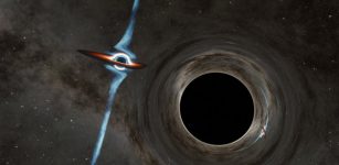 This artist's concept shows two candidate supermassive black holes at the heart of a quasar called PKS 2131-021. In this view of the system, gravity from the foreground black hole (right) can be seen twisting and distorting the light of its companion, which has a powerful jet. Each black hole is about a hundred million times the mass of our sun, with the black hole in the foreground being slightly less massive. Credit: Caltech/R. Hurt (IPAC)