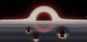 Illustration of a swarm of smaller black holes in a gas disk rotating around a giant black hole . Interactions between three black holes, such as those shown in the foreground, occur relatively often and will with high probability result in a merger on a non-circular orbit (credit: J. Samsing/Niels Bohr Institute)