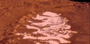 Perspective view of the South Polar Cap of Mars using Viking imagery draped over topography from the Mars Orbiter Laser Altimeter. White ice is residual carbon dioxide cap that resides on top of and protects the much thicker CO2 glaciers. The surrounding terrain is composed of red dust that overlies the mountains in the background and the 4 kilometer thick H2O ice cap that supports the CO2 glaciers. Credit: NASA data visualized using JMARS.