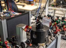 Alice, the receiver of the teleported quantum information. Inside the black aluminium cylinder, the diamond sample is cooled to -270°C, to reduce the noise from the environment and enable the quantum control. Credit: Marieke de Lorijn for QuTech