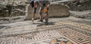 A worker cleans the mosaic on the floor of a recently discovered Roman villa in the Defne district of Hatay, southern Turkey, July 4, 2022. (AA Photo)