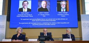 Secretary General of the Royal Swedish Academy of Sciences Hans Ellegren, centre, Eva Olsson, left and Thors Hans Hansson, members of the Nobel Committee for Physics announce the winner of the 2022 Nobel Prize in Physics, from left to right on the screen, Alain Aspect, John F. Clauser and Anton Zeilinger, during a press conference at the Royal Swedish Academy of Sciences, in Stockholm, Sweden, Tuesday, Oct. 4, 2022. Credit: Jonas Ekstromer /TT News Agency via AP